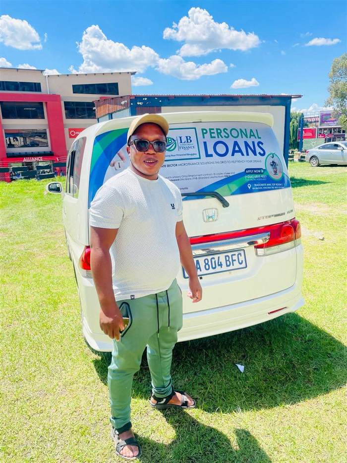 LB Microfinance branded vehicle and representative